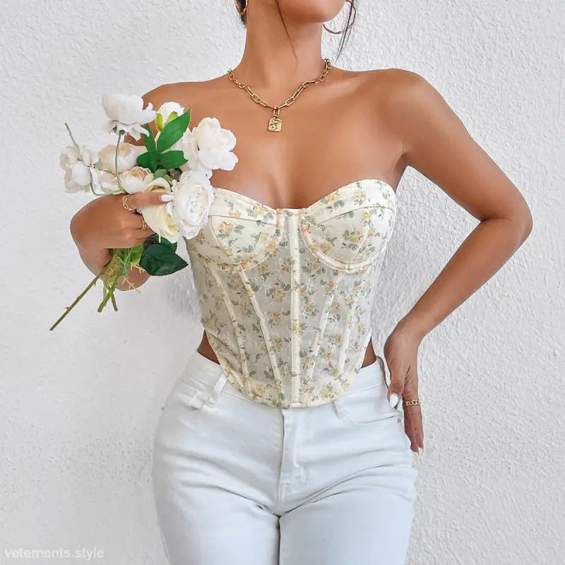 Floral vest with boning corset waist styled with white pants and gold necklace