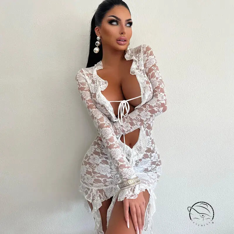 Woman in revealing white lace sheath dress with ruffles, plunging neckline, long sleeves, free shipping