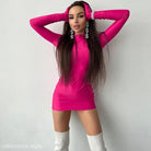 Woman in a hot pink sexy sheath long sleeve bodycon dress with white knee-high socks