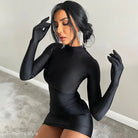 Woman in a sexy sheath long sleeve bodycon dress with gloves and dangling earrings