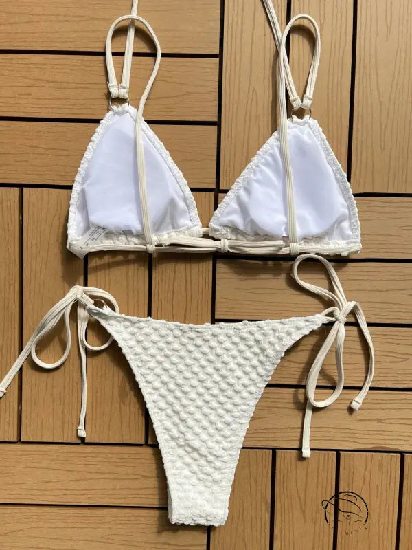 White string bikini with a triangle top and textured bottom.