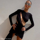 Woman confidently poses in a sexy slim jumpsuit with long sleeves and cutout design