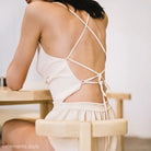 Backless white ice silk pajamas top with crisscross straps and low-cut design