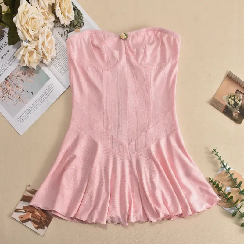 Pink strapless dress with a fitted bodice and flared skirt.