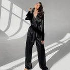 Elegant black silk jumpsuit featuring wide-leg pants, perfect for skin friendly cardigan pajamas