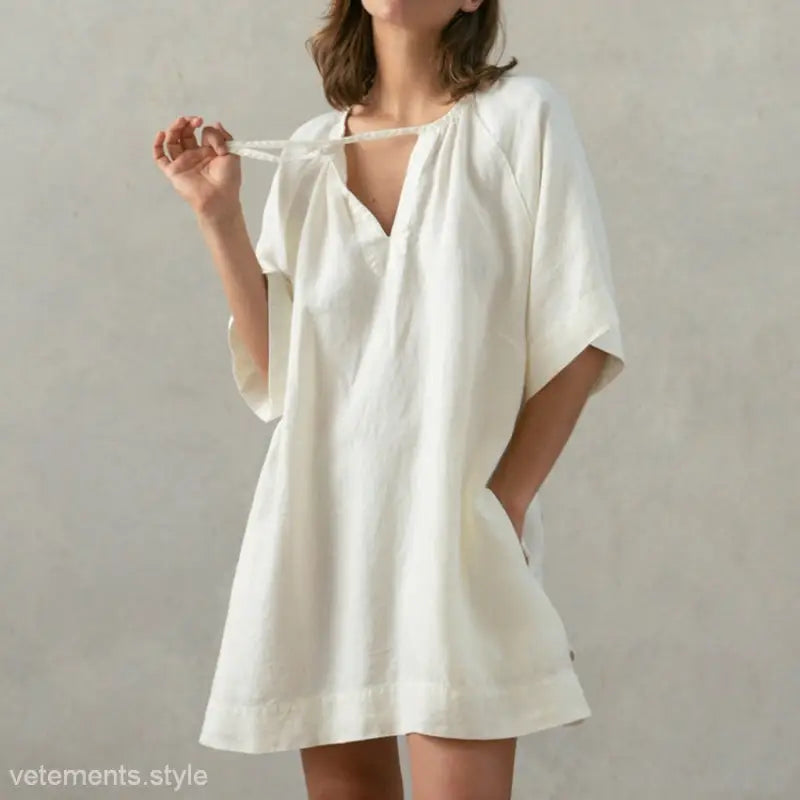 Loose-fitting soft cotton nightdress in off-white with pockets and tie sleeves in apricot