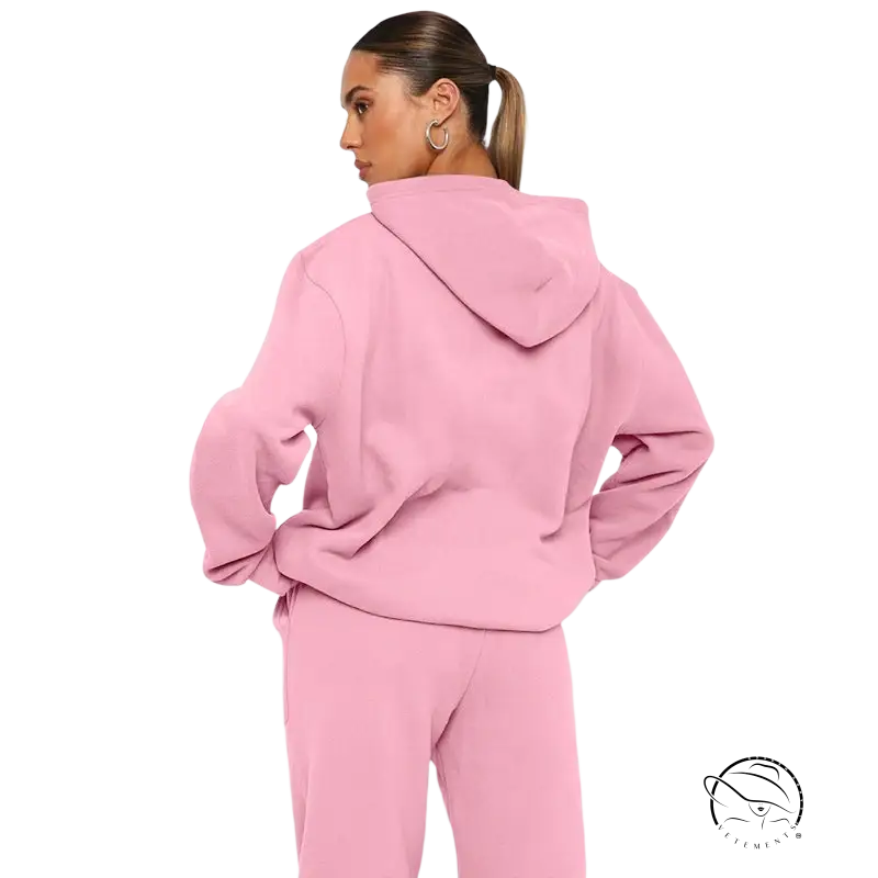 Woman in pink hooded sweatsuit: soft touch trousers with warm comfortable long sleeve sweater