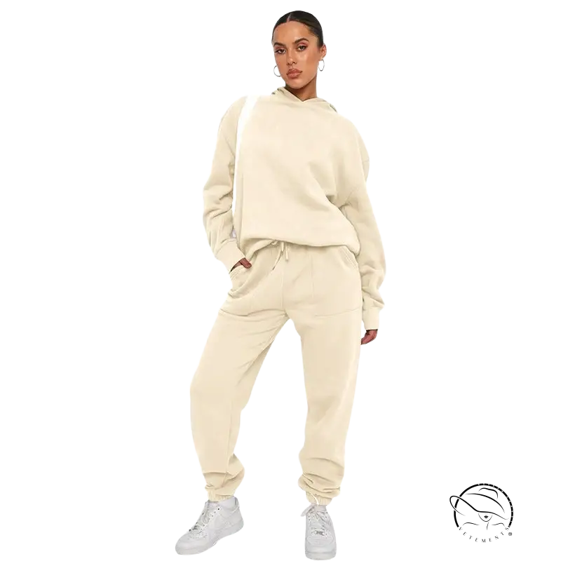 Woman in cream sweatsuit and white sneakers, soft touch trousers with warm comfortable long sleeve sweater