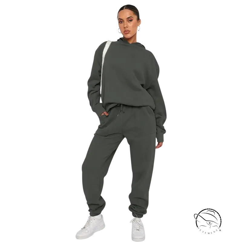 Woman in dark gray soft touch trousers and warm comfortable long sleeve sweater with white sneakers