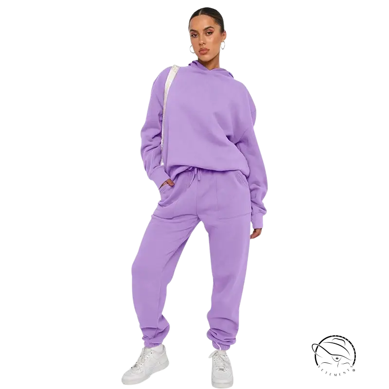 Woman in lavender soft touch trousers and warm comfortable long sleeve sweater with white sneakers