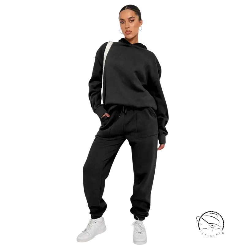 Woman in black soft touch trousers, warm comfortable long sleeve sweater, white sneakers