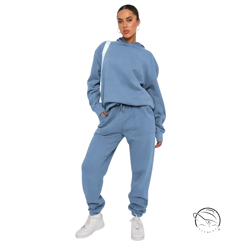 Woman in light blue soft touch trousers, warm comfortable long sleeve sweater, white sneakers