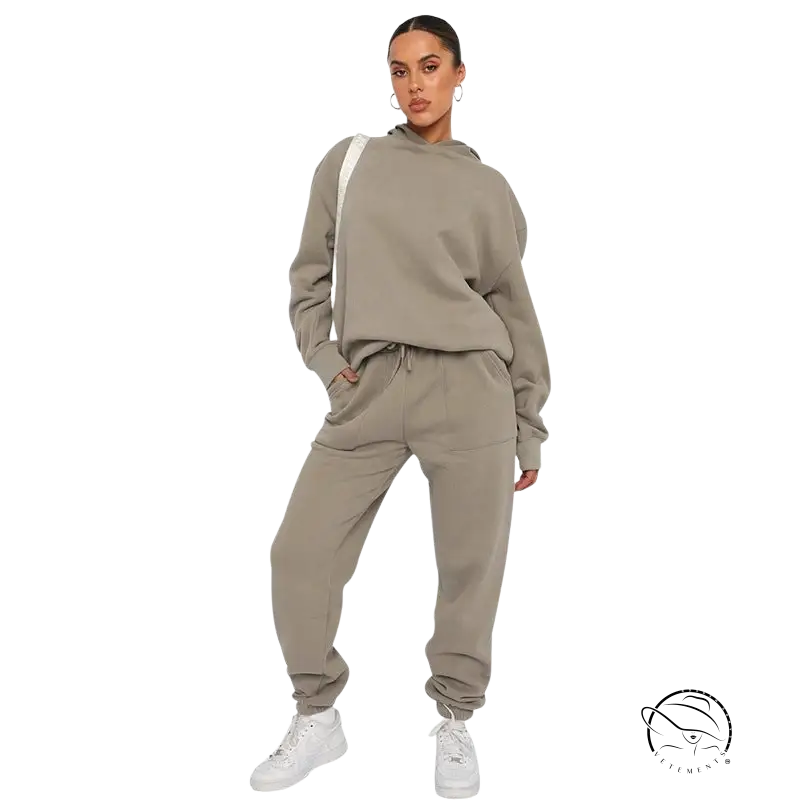 Woman in beige soft touch trousers, warm comfortable long sleeve sweater, white sneakers