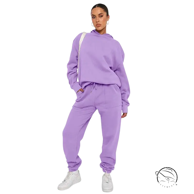 Woman in lavender soft touch trousers and warm comfortable long sleeve sweater with white sneakers