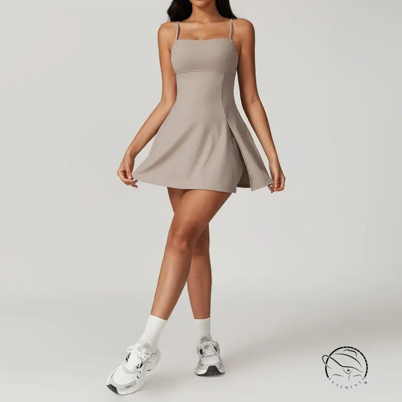 Beige sleeveless mini dress in colored glaze blue and barbie pink with white socks and chunky sneakers