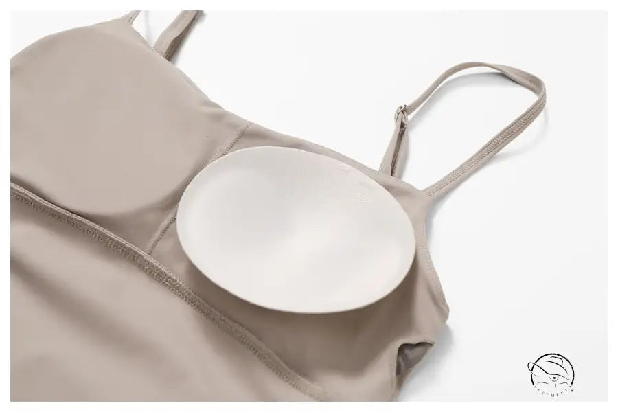 White circular breast form in beige bra with barbie pink sporty backless split dress