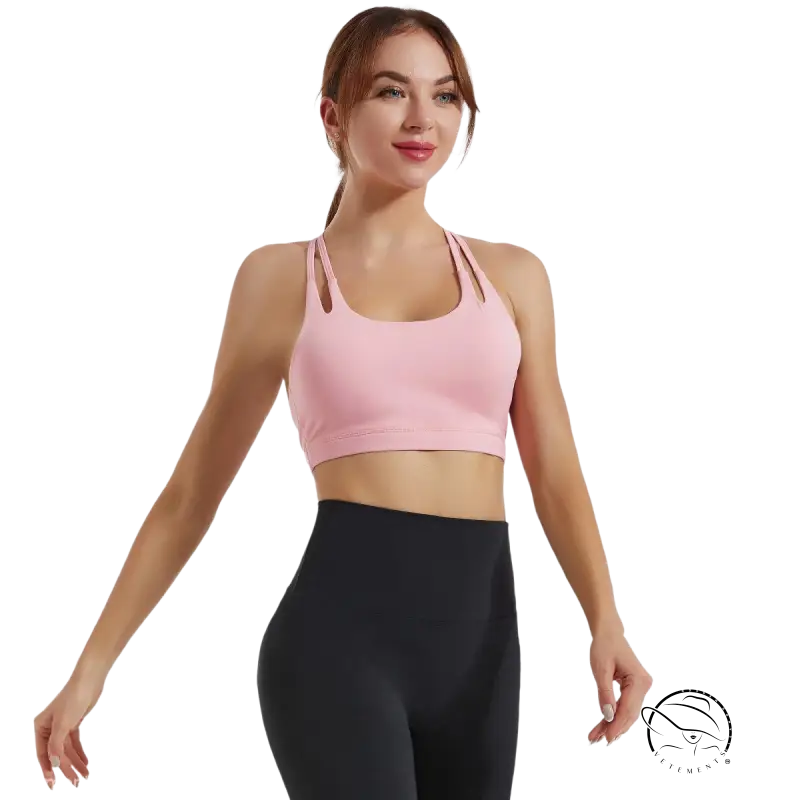 Woman in hydrangea purple fitness bra and black leggings in athletic pose