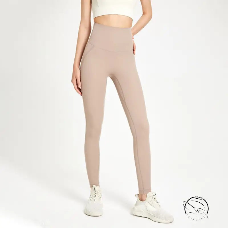 Sporty high rise nylon pants in wild berry color with beige leggings and white sneakers