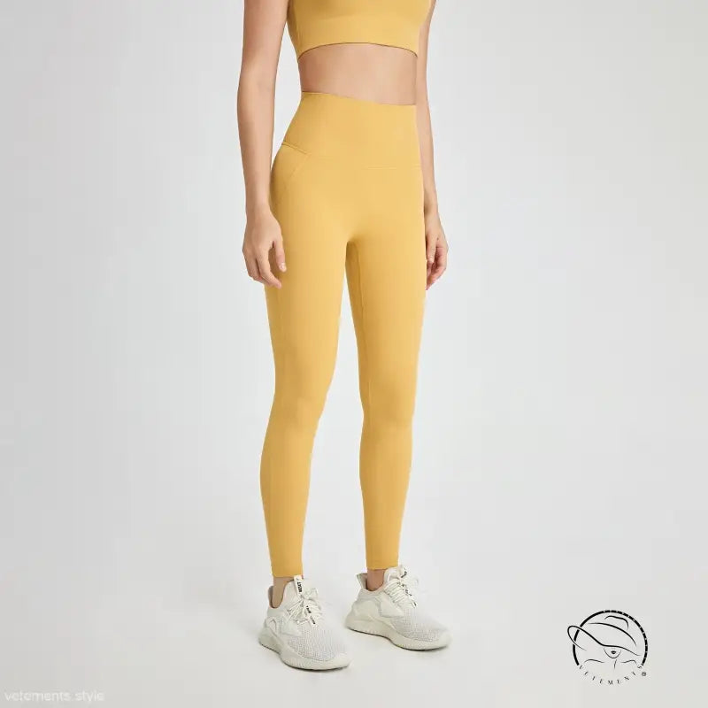 Mustard yellow high-waist leggings in wild berry color with white sneakers