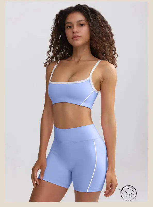 Woman in light blue sports bra and high-waisted summer yoga shorts