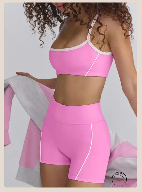 Bright pink sports bra and high-waisted shorts in summer yoga clothes