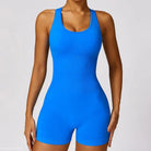 Blue ribbed athletic romper styled as a yoga bodysuit for active wear in Volcanic Ash