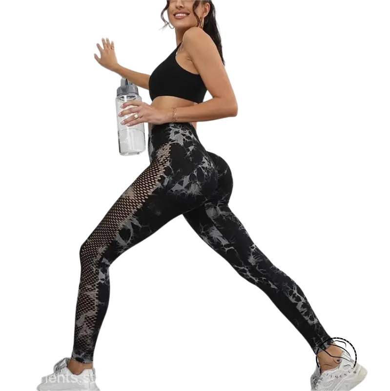 Woman in black sports bra and hot black fitness pants with tie-dye pattern