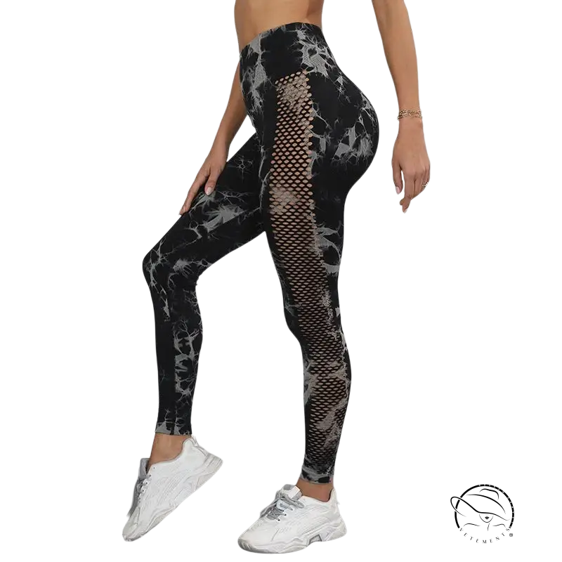 Black high-rise tie-dye nylon fitness pants with patterned mesh panels
