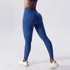 Blue high-waisted athletic leggings paired with white sneakers in Night Sky Blue