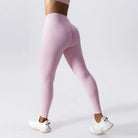 Pale pink high-waisted leggings with white sneakers, featured in Cherry Blossom Powder color