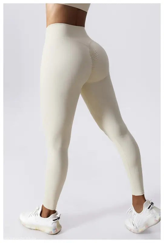 White high-waisted leggings with white sneakers; Sporty Nylon Solid Pants in Cherry Blossom Powder