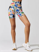 Colorful patterned cycling shorts paired with white sneakers in a Printing Elastic Fitness Suit