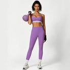 Woman in purple workout set holding kettlebell for waist hip lift training