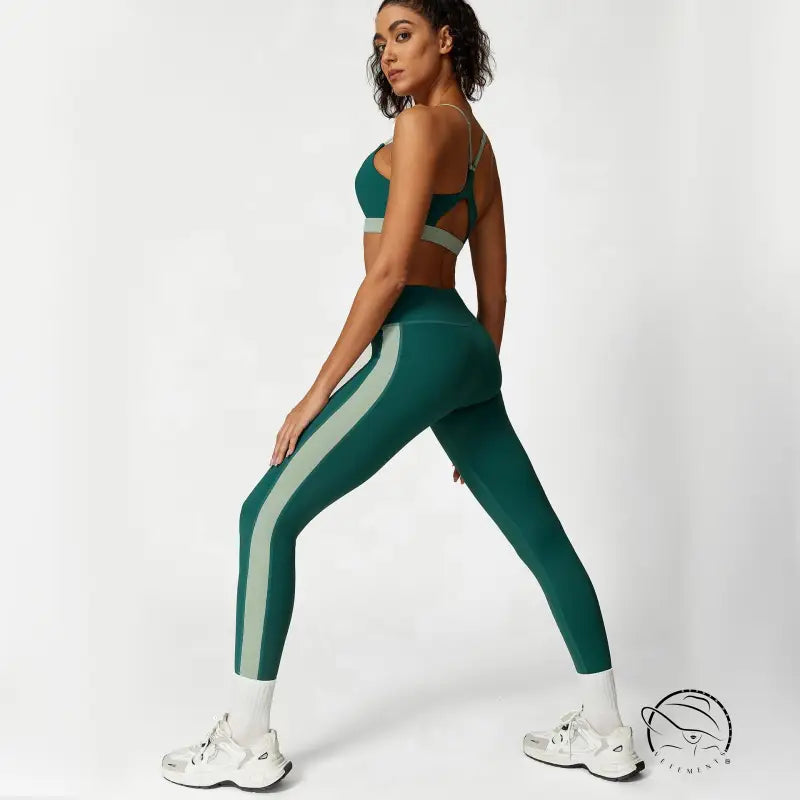 Woman in deep emerald sage green athletic wear for waist hip lift