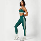 Woman in green athletic wear showcasing the Sporty Slim Nylon Color Block Cutout Set for waist hip lift
