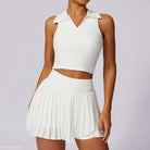 White two-piece outfit featuring a crop top and pleated mini skirt in Swan White Suit