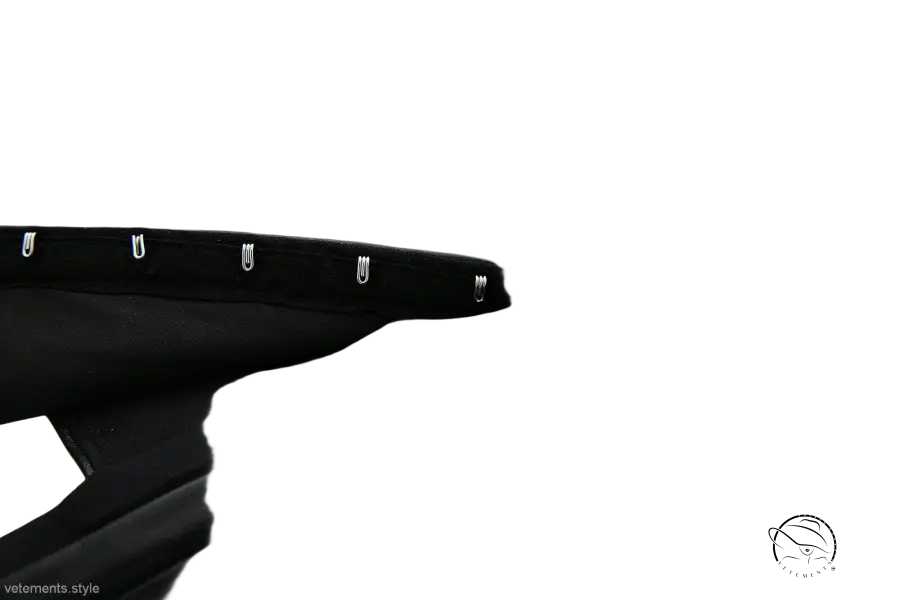 Strapless faux leather corset with black pleated skirt and silver clips