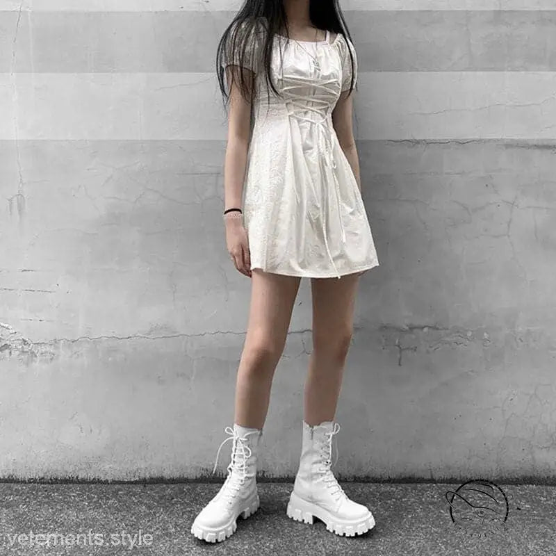 White mini dress with stylish lace-up platform boots