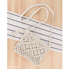 Cream-colored macramé handbag with braided handles for the Bohemian Beach Bag