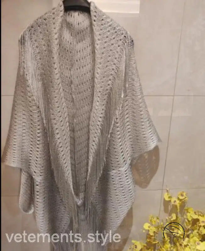 Talma shawl beach cover in off-white open-weave with fringe sleeves