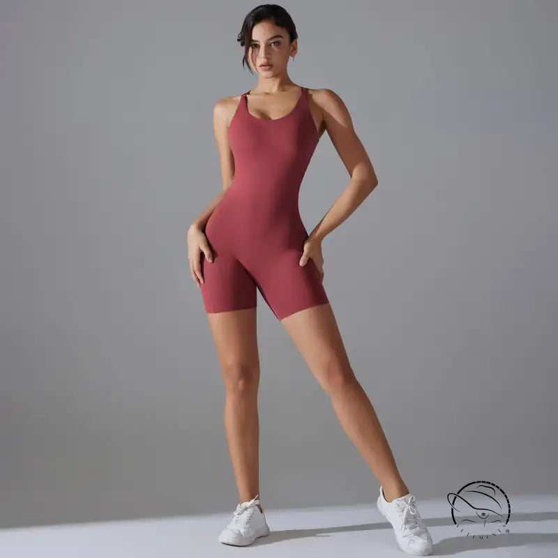 Woman in wine red backless one-piece yoga top and white sneakers
