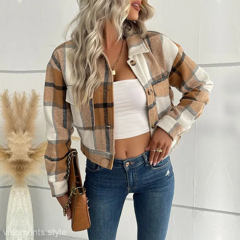 Plaid long sleeve cropped jacket over white crop top and blue jeans, ideal winter attire